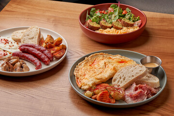 A close-up of a breakfast plate, showcasing the crispy bacon, fluffy scrambled eggs, and fresh...
