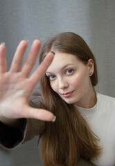 Fototapeta premium girl 20-25 years old, with her arm extended forward, dressed in