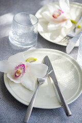 Table setting with fresh orchid flowers