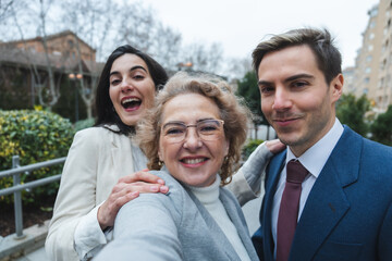 Happy family taking a selfie outdoors in urban setting