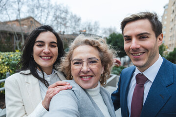 Happy business team smiling together outdoors in urban setting