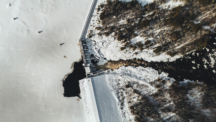 Aerial view of hydroelectric dam and river in winter, Maine