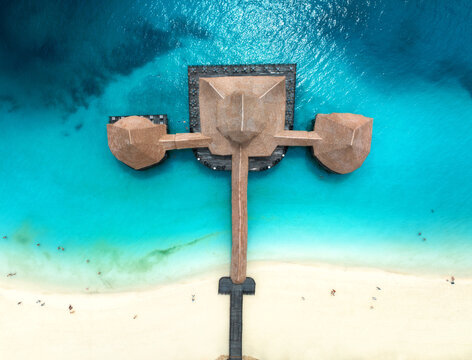 Aerial view of bungalow, white sandy beach, blue sea