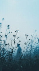 Solitary figure veiled in misty blue wildflowers