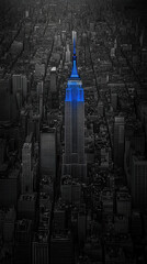 Iconic skyscraper glowing blue amidst a city.