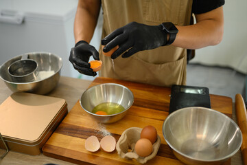 Baker separating eggs preparing for a delicious batch of homemade cookies