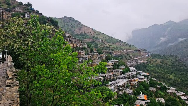 Misty hillside village with terraced homes and lush greenery under a foggy sky.
📍Hawraman Takht - Kurdistan 
