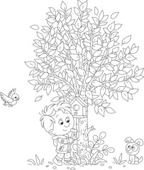 Happy little boy with his funny puppy nailing a small wooden homemade birdhouse to a tree in a spring park, black and white outline vector cartoon illustration for a coloring book
