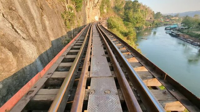 The 'Death Railway' Bridge,at sunset,part of the Thai-Burma Railway, constructed using forced labor of prisoners of war by the Japanese army during World War 2,near Kanchanaburi,Thailand.
