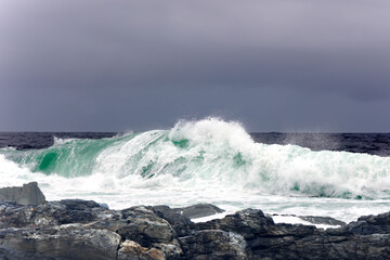 Large Indian Ocean waves and rocky coastline in Tsitsikamma, Garden Route National Park, Eastern Cape. South Africa	