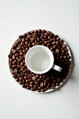Naklejka premium Aromatic Coffee Beans Encircling an Empty Espresso Cup on a Pristine White Surface