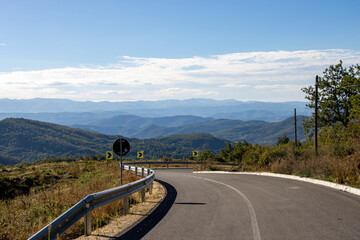 Fototapeta premium landscape with blue sky and road with traffic sign for right turn.