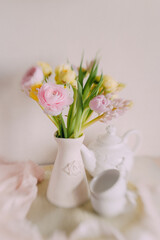 Soft Spring Table Setting with Pastel Flowers and Vintage Decor