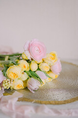 Soft Pastel Ranunculus and Yellow Roses in a Glass Vase