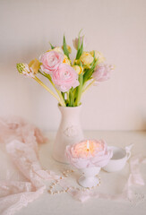 Soft Pastel Ranunculus and Yellow Roses in a Glass Vase