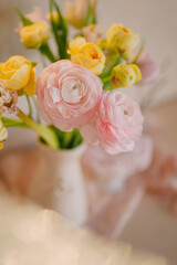 Soft Pastel Ranunculus and Yellow Roses in a Glass Vase