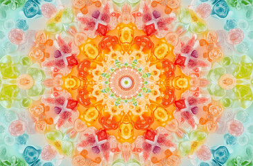 A kaleidoscopic pattern of colorful gummy candies forms an intricate mandala, with bright colors like orange and pink on the outside for contrast against a blue background