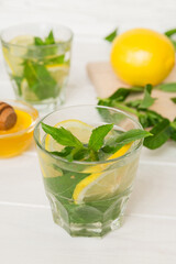 Mojito cocktail. Refreshing mojito cocktail with lime, lemon and mint in a tall glass with a stick
