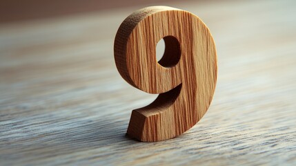 Wooden number nine on table, light background