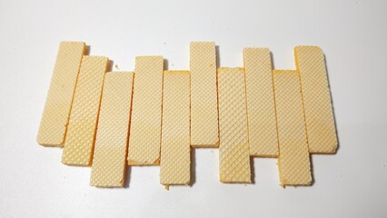ten stacked layered wafers, with cheese paste, on an isolated white background