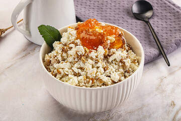 Curd with granola and orange jam