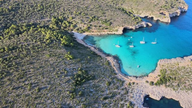 Experience the stunning landscapes of Cala Varques in Porto Cristo, Majorca. Clear turquoise waters contrast with lush greenery, ideal for relaxation and adventure. Enjoy the peaceful vibes.