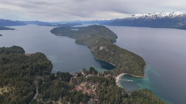 Amazing panoramic aerial movement over the Parque Nacional Los Arrayanes with serene Nahuel Huapi lake, Argentina.