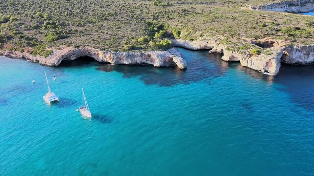 Discover the breathtaking turquoise waters and rocky coastline of Cala Varques in Porto Cristo, Majorca. Perfect for sailing, swimming, and enjoying nature's tranquility.