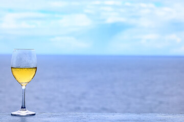a glass of white wine on the background of the sea relaxing by the sea with wine