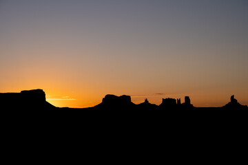 Beautiful sunrise with the silhouette of Monument Valley in the United States.