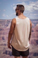 Unrecognizable young man visiting the impressive Grand Canyon of the Colorado River in the United States.