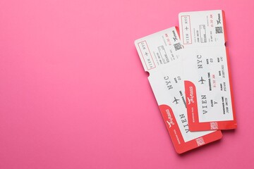 Travel agency. Flight tickets on pink background, top view. Space for text