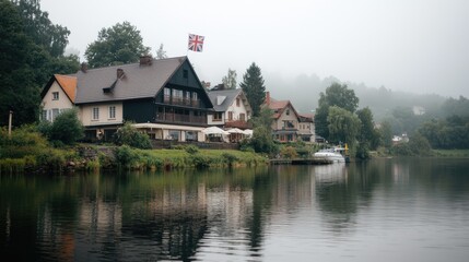 Fototapeta premium European Village by River in Misty Morning