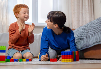 Mother and son playing house builder at home