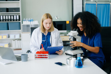  Doctors and nurses using laptops and clipboards, showcasing teamwork, modern healthcare.