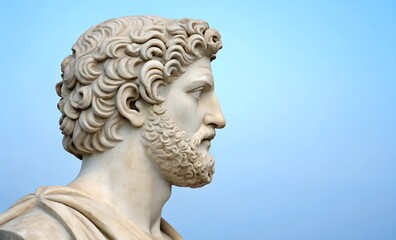  A Greek philosopher&rsquo;s marble bust in profile against a turquoise background. Aesthetic and historical design with text placement space.
