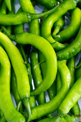 Green chilies background. Close-up green chillie texture. Concept of greenery, abstract, freshness,...