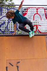 Dynamic youth in action! Leaping over the ramp with grace, defying gravity with skill. Active...