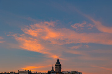 Fototapeta premium Galata tower with orange clouds at sunset. Visit Istanbul