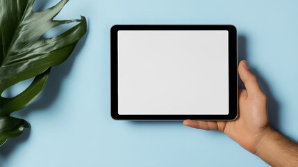 Person is holding a tablet with a white screen
