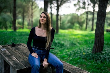 Obraz premium Woman sitting in a serene park setting