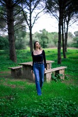 Naklejka premium Woman walking in a lush green forest.