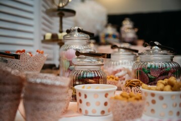 Assorted candies and snacks on a dessert table.