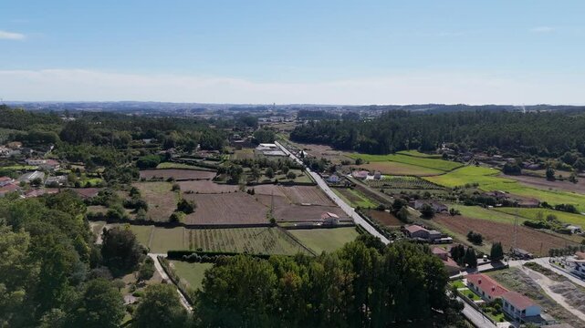 Aerial view of Trofa Portugal featuring rural fields, scattered houses, and distant horizon