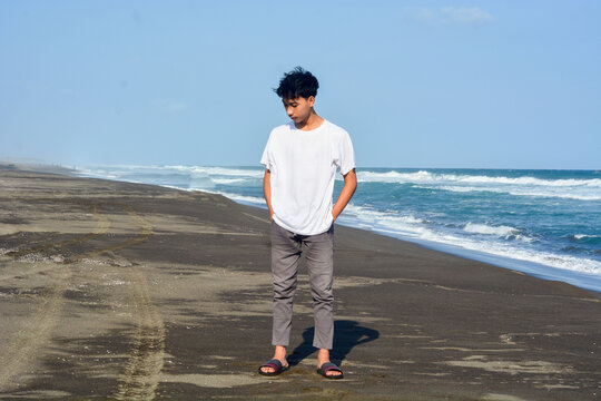 January 18 2025, Asian man enjoying the beach atmosphere, Kebumen, Indonesia