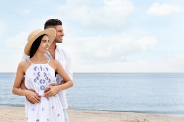 Lovely couple spending time together on beach. Space for text