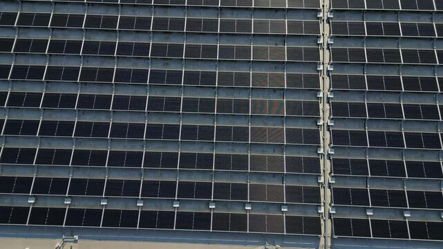 extensive roof of industrial and logistic hall are gradually being filled with solar panels. covering roofs helps industrial developer increase energy efficiency and sustainability site, building 