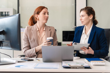 Diverse Business Team Discusses Financial Project Analysis in Meeting.