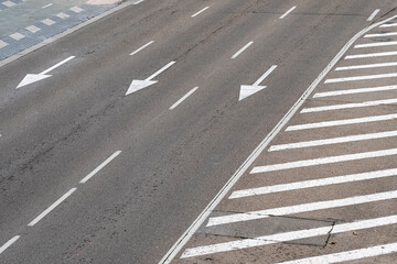 Multiple lanes of a highway with directional arrows and clear road markings, viewed from above.