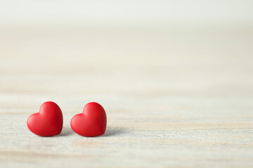 Valentine's Day. Decorative hearts on white wooden background, closeup. Space for text